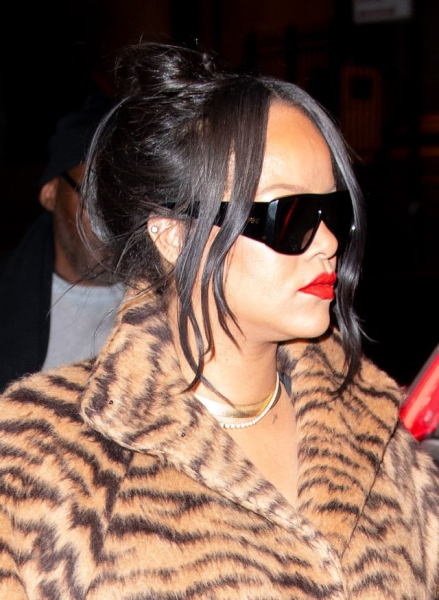 Rihanna wearing a tiger print fur coat and sunglasses