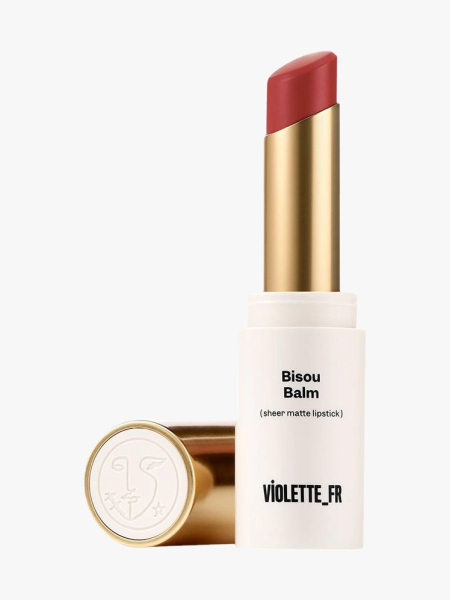 Violette_FR Bisou Balm Sheer Matte Lipstick in Bêtise white and gold twist tube of berry lipstick on light gray background